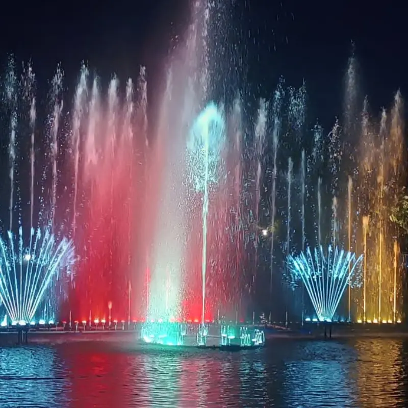 Dancing musical fountain with synchronized water jets, colorful lights, and dynamic patterns
