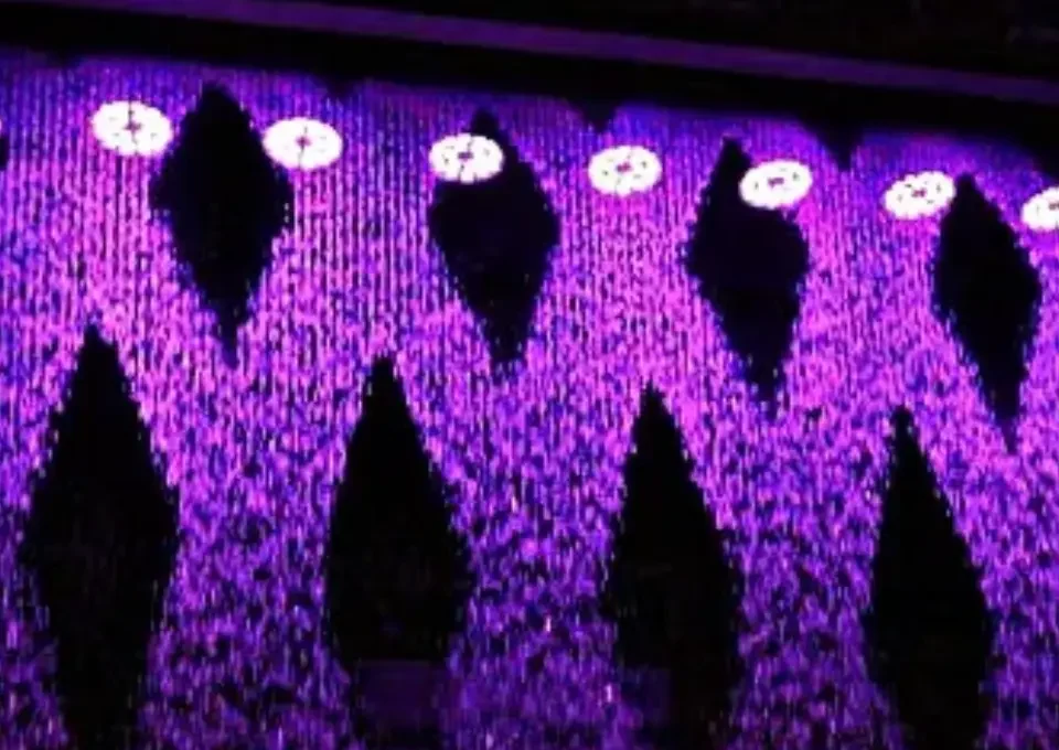 Digital water curtain displaying text and patterns using controlled falling water streams